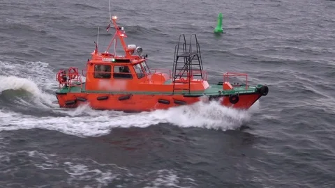 Small fast pilot motorboat from Riga port sails past boy Stock Footage 116611140