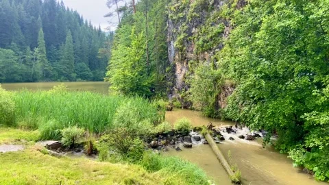A small fast river flows out of Red Lake. Large stones in the river. Stock Footage 250789603