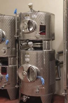 Small fermentation tanks in a small UK Vineyard Stock Photos
