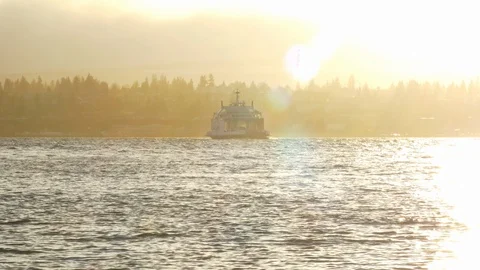 A small ferry boat makes a crossing in bright sunset Stock Footage 102864976
