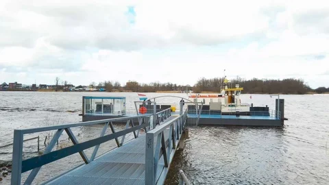 Small ferry docking at jetty at Kinderdijk windmills location 動画素材 104779518