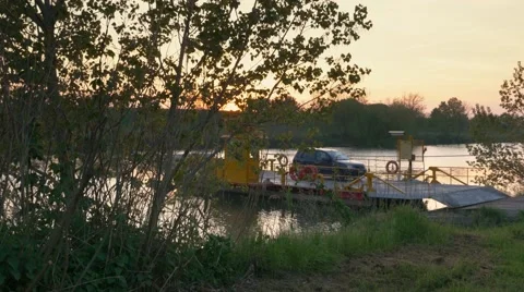 Small Ferry on a river at sunset Stock Footage 62068851
