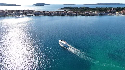 A small ferry sails towards the island Stock-Footage 268608643