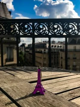 A small figure of the Eiffel Tower on the background of Paris Stock Photos