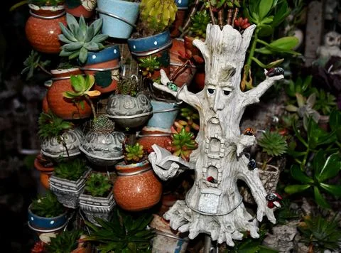 Small figure of the tree of wisdom surrounded by small ladybugs Stock Photos