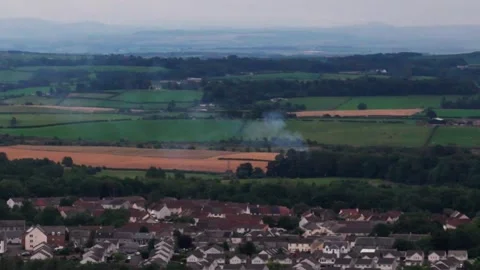 Small Fire and Smoke Across Rural Landscape Near Homes, Aerial Vídeo Stock 343420162