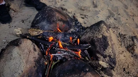 Small fire burning surrounded by pebbles Stock Footage 168886649