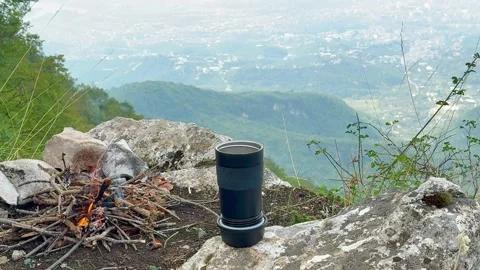 Small fire with cup tea mountain view Stock Footage 318287264