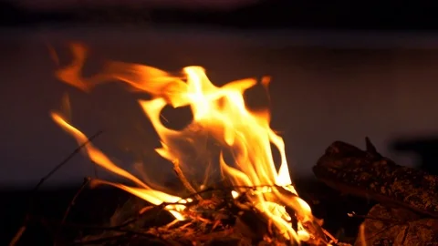 Small fire by lake at sunset 스톡 동영상 102906112