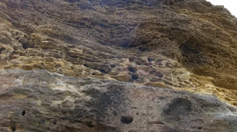 Small fire on the sand near the wall of yellow shell rock. Picnic on beach. Stock Footage 65219225