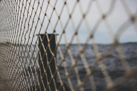 A small fish net in the background of the lake. Stock Photos