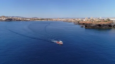Small Fishboat With Divers Navigating close to coast In Mediteranean Sea, S Stock Footage 124847344