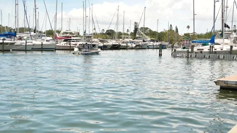 Small fishing boat passing by left to right. View into Gulfport Marina. Editoria Stock Footage 312707280