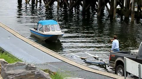 A small fishing boat pulls onto the trailer Stock Footage 10743826