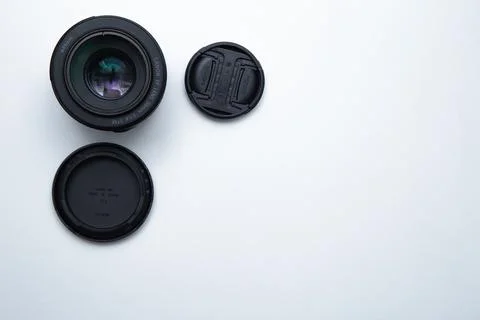 A small fixed lens for a professional camera on a white background with two Stock Photos