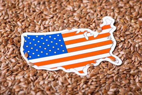 Small flag and map of USA on flax grain Stock Photos