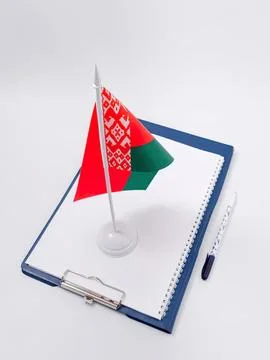 Small flag of belarus on notebook with pen and paper Stock Photos