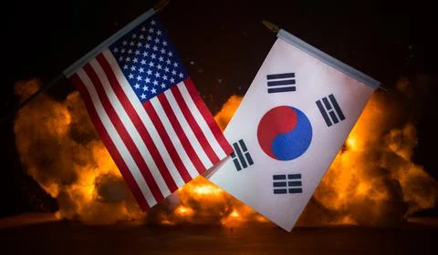 Small flag on burning dark background. Concept of crisis of war and political Stock-Fotos