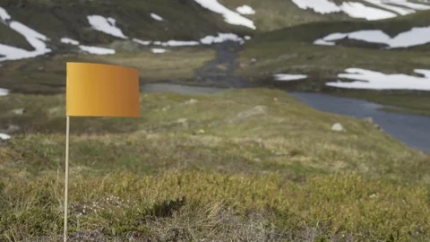 Small flag planted in the grass in a middle of a prairie, Tromso, Norway Video stock 102154691