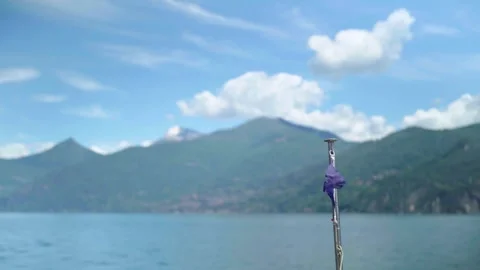 Small flag in wind in front of ferry on Lake Como Italy Stock Footage 277029584