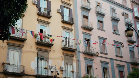Small flags of all nationalities hanging between the buildings of Naples Stock Footage 341562994