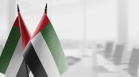 Small flags of the Arab Emirates on an abstract blurry background Stock Illustration