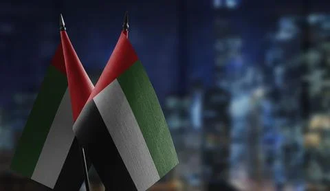 Small flags of the Arab Emirates on an abstract blurry background Stock Illustration