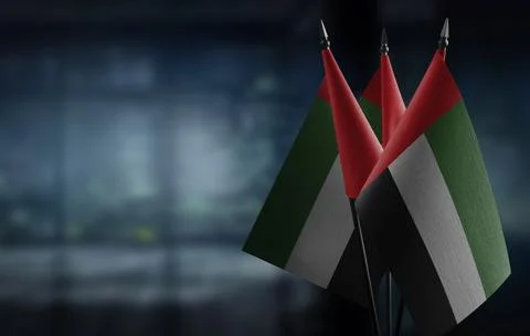 Small flags of the Arab Emirates on an abstract blurry background Stock Illustration