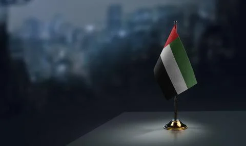 Small flags of the Arab Emirates on an abstract blurry background Stock Illustration