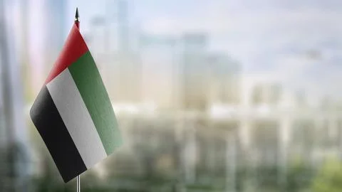 Small flags of the Arab Emirates on an abstract blurry background Stock Illustration