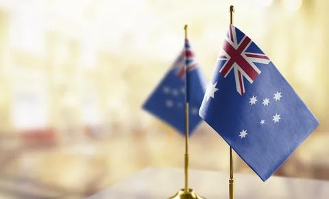 Small flags of the Australia on an abstract blurry background Stock Illustration