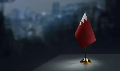 Small flags of the Bahrain on an abstract blurry background Stock Illustration