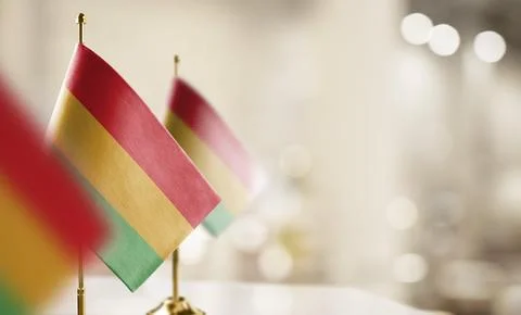 Small flags of the Bolivia on an abstract blurry background Stock Illustration
