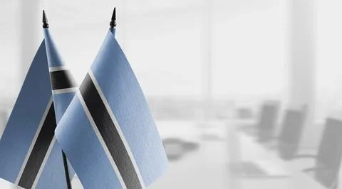 Small flags of the Botswana on an abstract blurry background Stock Illustration