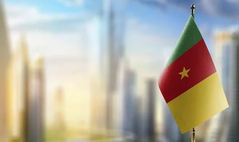 Small flags of the Cameroon on an abstract blurry background Stock Illustration