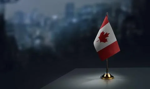 Small flags of the Canada on an abstract blurry background Stock Illustration