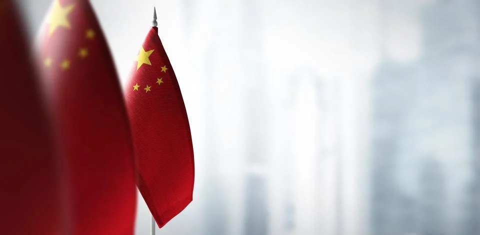 Small flags of China on a blurry background of the city Stock Photos