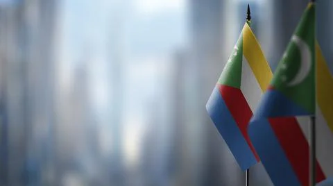 Small flags of the Comoros on an abstract blurry background Stock Illustration