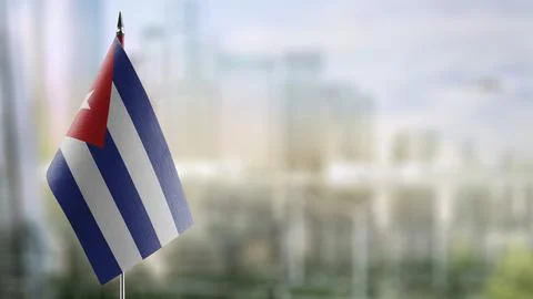 Small flags of the Cuba on an abstract blurry background Stock Illustration