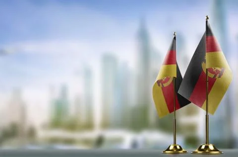 Small flags of the GDR on an abstract blurry background Stock-Illustration
