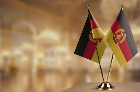 Small flags of the GDR on an abstract blurry background Stock-Illustration