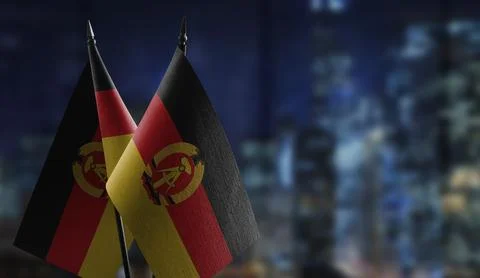 Small flags of the GDR on an abstract blurry background Stock-Illustration