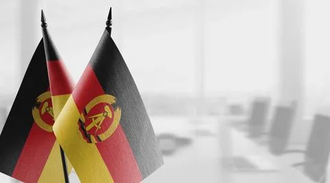 Small flags of the GDR on an abstract blurry background Stock-Illustration