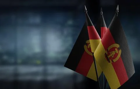 Small flags of the GDR on an abstract blurry background Stock-Illustration