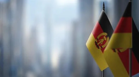 Small flags of the GDR on an abstract blurry background Stock-Illustration