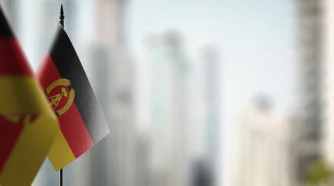 Small flags of the GDR on an abstract blurry background Stock-Illustration