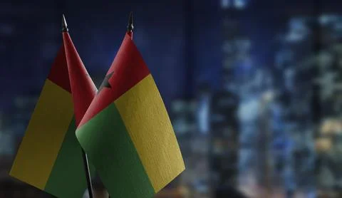 Small flags of the Guinea Bissau on an abstract blurry background Stock Illustration