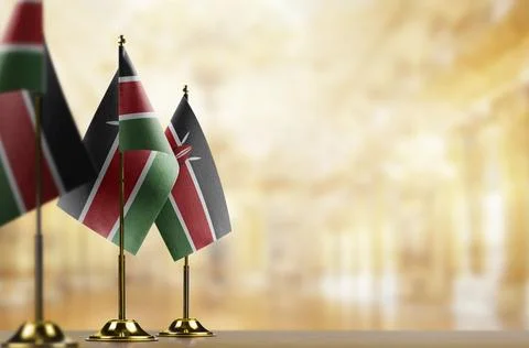 Small flags of the Kenya on an abstract blurry background Stock Illustration