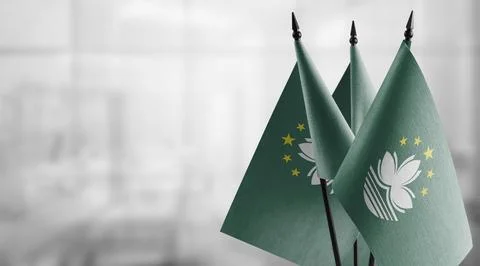 Small flags of the Macao on an abstract blurry background Stock Illustration