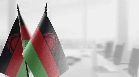 Small flags of the Malawi on an abstract blurry background Stock Illustration